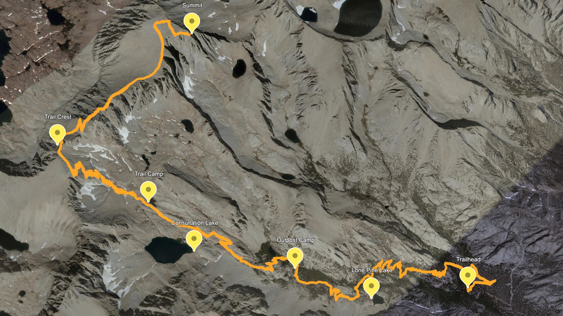 A line of hikers on the Mount Whitney Trail near Trail Crest with rocky switchbacks and the Sierra Nevada ridgeline in late summer, real outdoor photography style