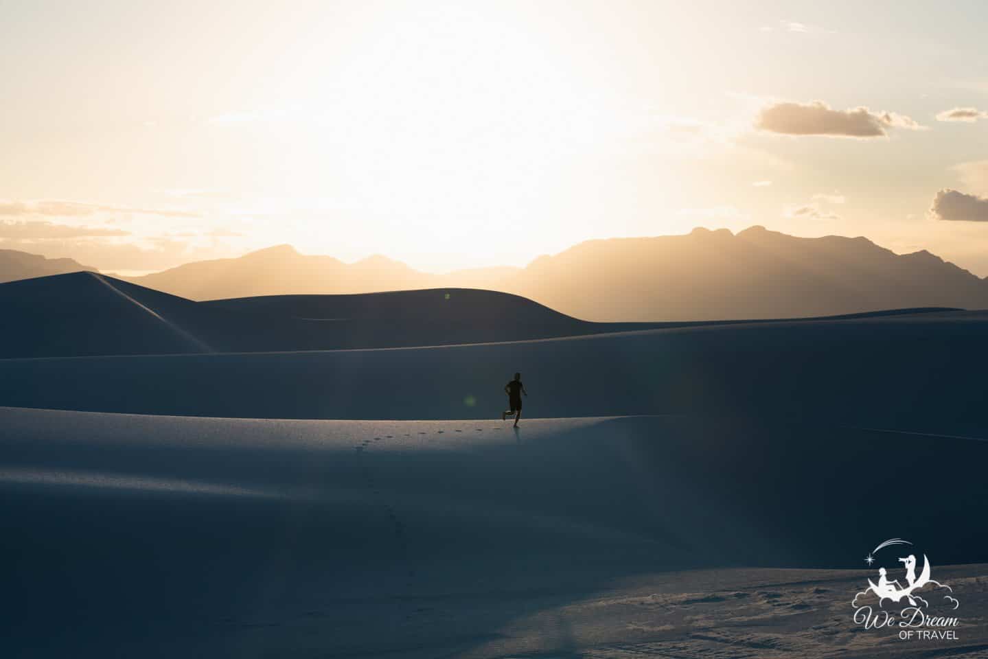 A real photograph of long evening shadows stretching across rippled white dunes at golden hour in White Sands National Park