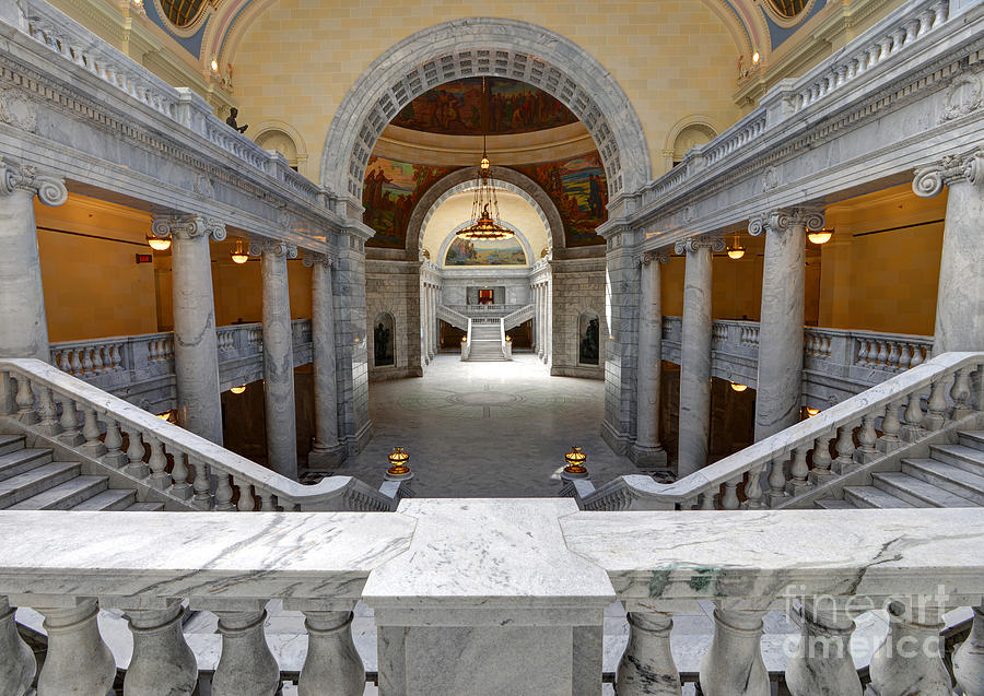 A real photograph of the Utah State Capitol in Salt Lake City taken from the front steps, with the dome centered and the city stretching out behind