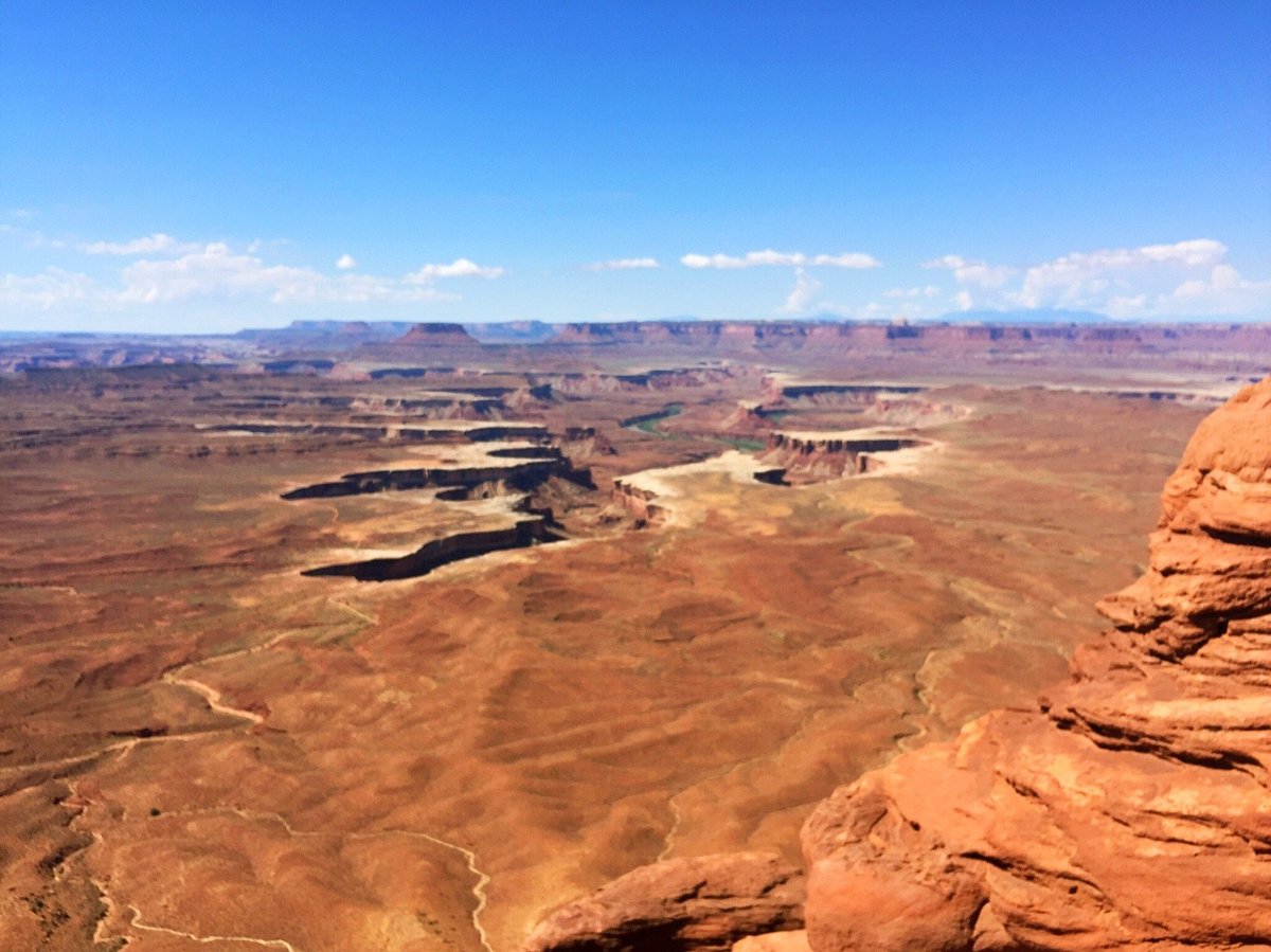 A wide canyon panorama from Island in the Sky with layered mesas and a river far below