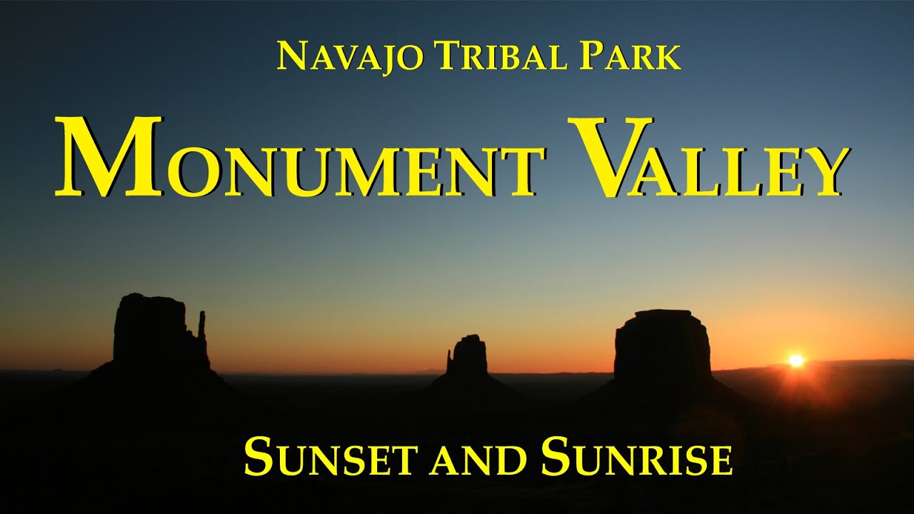 A wide sunrise photograph of Monument Valley Tribal Park taken from near The View Hotel, with glowing red buttes and long shadows stretching across the desert