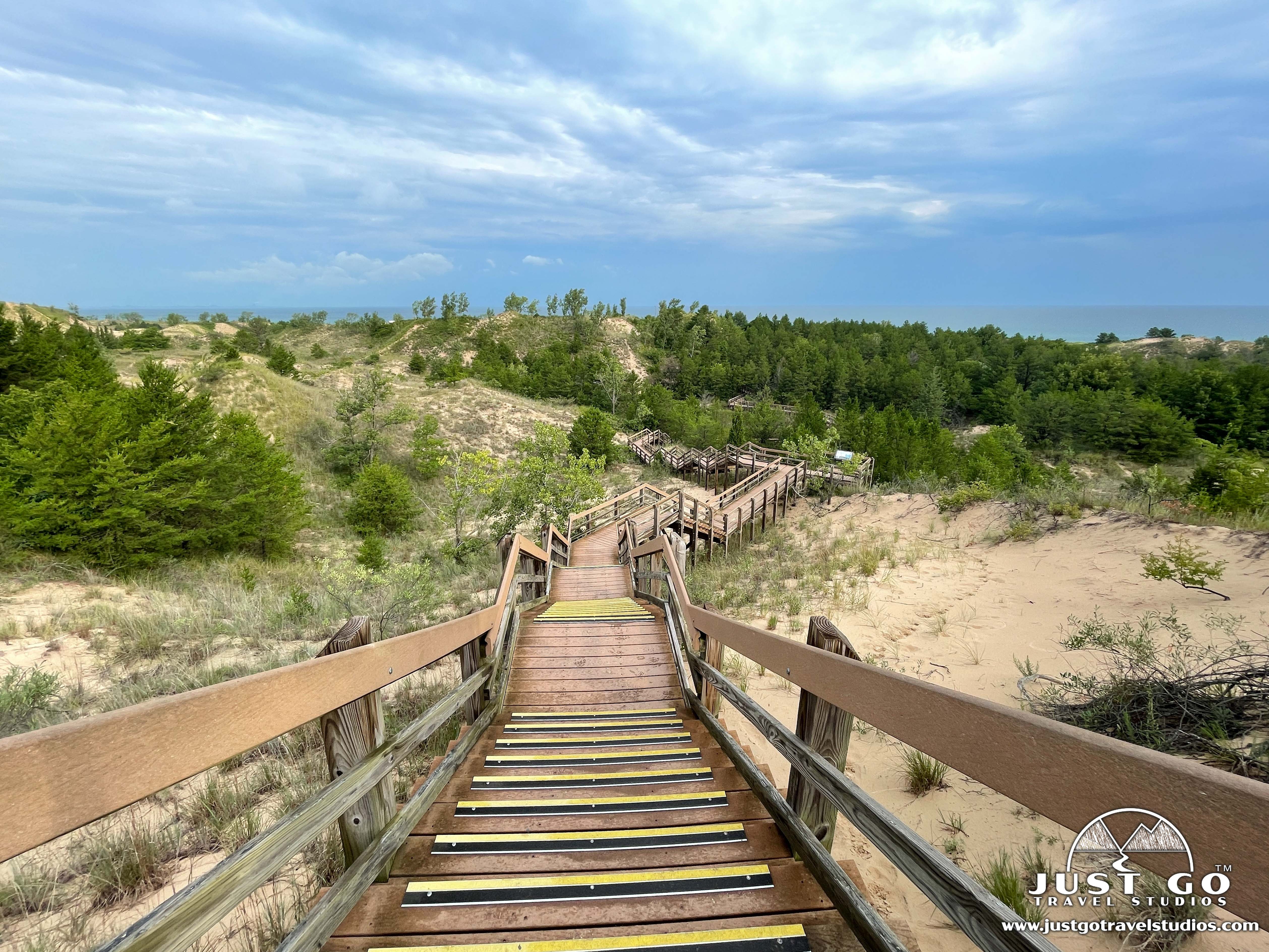 A wooden boardwalk crossing a green marsh with reeds and open sky at Indiana Dunes National Park