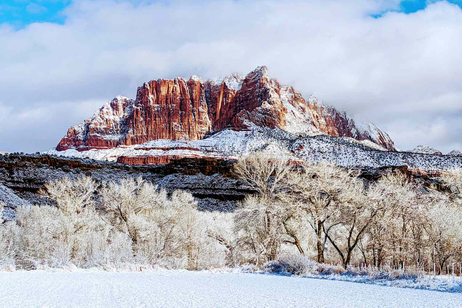 Close-up of hiking boots with microspikes on an icy shaded Zion trail