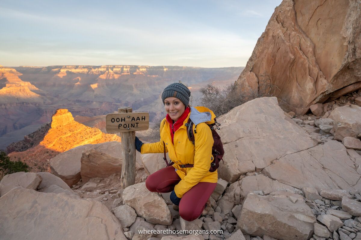 Early morning hikers descending the South Kaibab Trail on the South Rim with layered canyon walls glowing in sunrise light, real travel photography