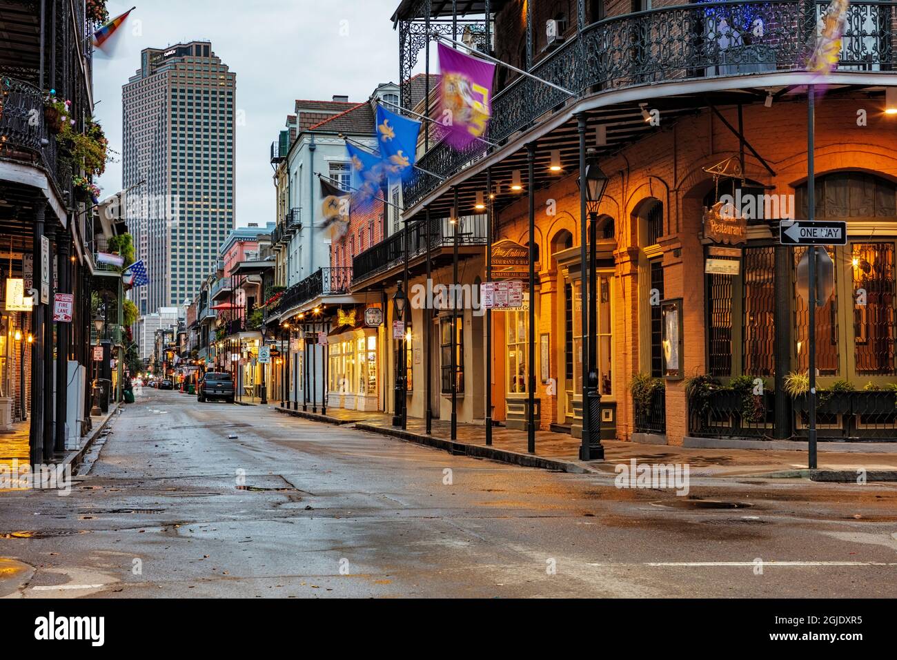 Early morning on Royal Street in New Orleans' French Quarter with wrought-iron balconies, pastel buildings, and quiet, sunlit sidewalks, real travel photography style